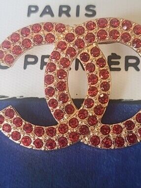 Iconic Goldtone Brooch with Red Crystal Accents